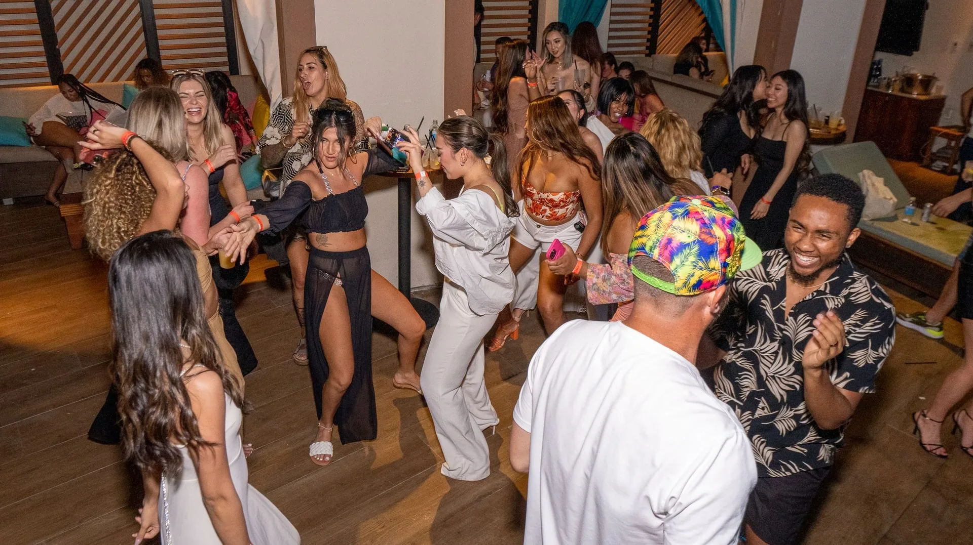 Attendees dancing at the party at PMU World 2023, the Seminole Hard Rock Hotel & Casino in Hollywood, Florida