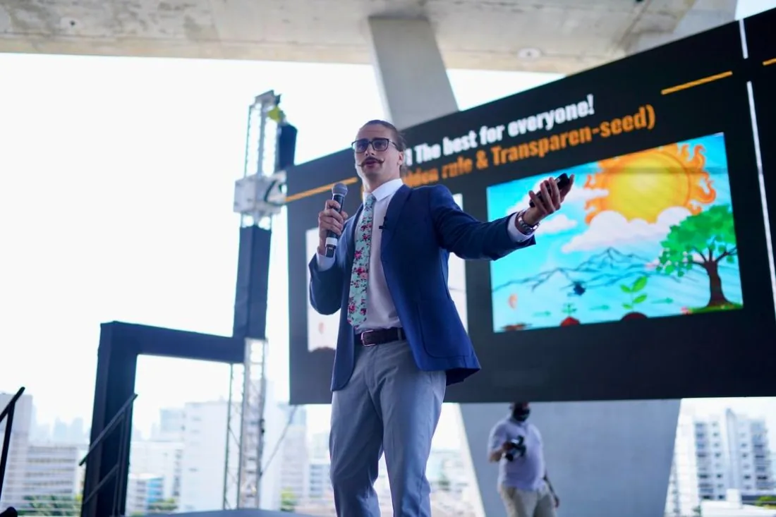 Speaker presenting in front of a slide on the main stage at Scaling With Systems LIVE in Miami